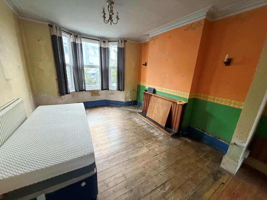 Lot: 125 - MID-TERRACE HOUSE FOR IMPROVEMENT - Living room showing fire place